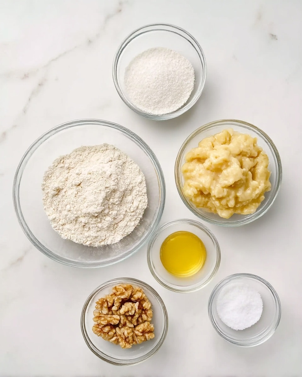 The image shows six clear glass bowls placed on a white marbled surface, each containing different ingredients for baking. The largest bowl in the front left holds white flour with a soft, powdery texture. To its right is a medium bowl with mashed bananas that have a chunky, creamy look and a pale yellow color. Behind the mashed bananas, a small bowl contains a golden-yellow liquid, likely melted butter or oil, looking smooth and shiny. Behind the flour is a bowl filled with white granulated sugar that looks fine and crystalline. Next to it is a small bowl of chopped walnuts, showing a rough texture and light brown color. The last small bowl at the top right has white fine salt reflecting light slightly. The bowls are arranged neatly with enough space between them, all on a white marbled surface. Photo taken with an iphone --ar 4:5 --v 7