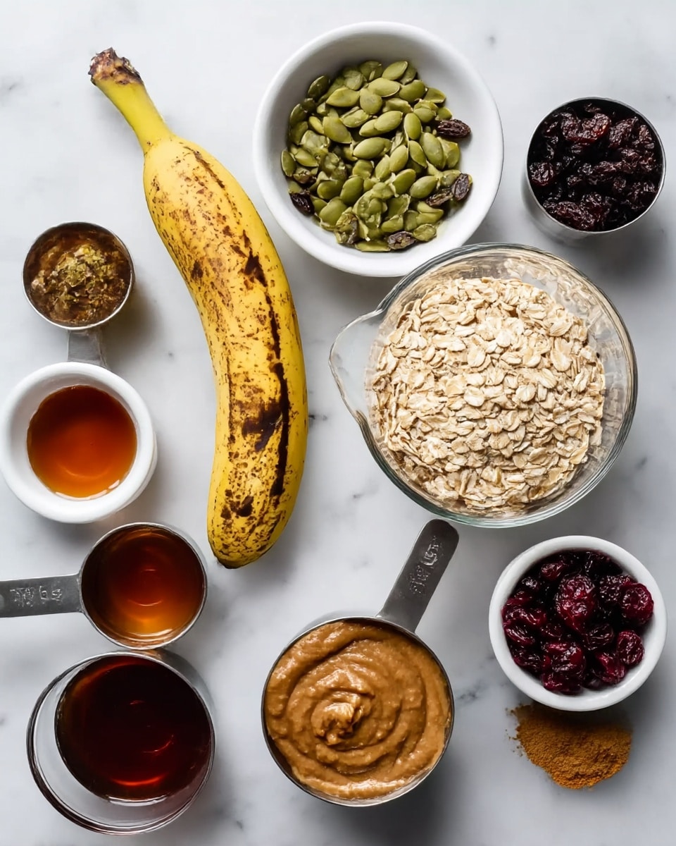 The image shows nine ingredients arranged on a white marbled surface: a ripe banana with brown spots in the center; a clear glass bowl filled with light brown rolled oats on the right; a white bowl with green pumpkin seeds on the top left; a stainless steel measuring cup holding dark raisins above the banana; another stainless steel measuring cup filled with a thick, light brown almond butter below the banana; a white bowl with dark red dried cranberries on the right side; a small glass bowl with amber liquid, likely maple syrup, on the bottom left; a stainless steel measuring cup filled with a dark brown paste, possibly applesauce, under the almond butter; and a small glass bowl containing ground cinnamon in the bottom right corner. Photo taken with an iphone --ar 4:5 --v 7