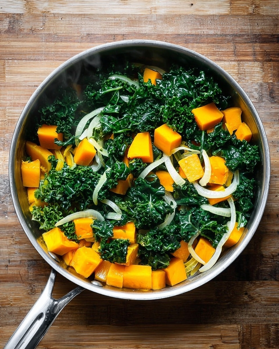 A metal pan filled with a mix of cooked vegetables sits on a wooden surface, replaced in the final prompt with a white marbled texture. Inside the pan, there are three main layers: large, bright orange cubes of squash spread evenly at the bottom, followed by fresh dark green curly kale leaves that have a slightly wilted texture layered over the squash, and thin, translucent white onion slices scattered throughout and resting on top of the kale and squash. Steam rises gently from the pan, showing the food is hot and freshly cooked. The pan has a shiny metal handle extending to the right side of the image. photo taken with an iphone --ar 4:5 --v 7