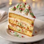 Sugar Cookie Cheesecake with Christmas Sprinkles and White Chocolate Ganache Recipe