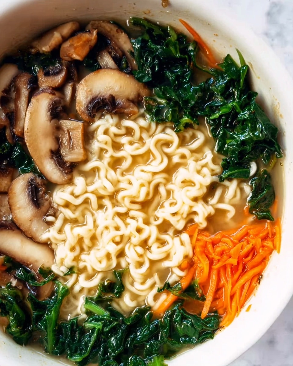 The image shows a close-up of a bowl filled with ramen noodles in a light broth. The noodles are pale yellow, thick, and curly, sitting in the middle part of the bowl. Around the noodles are dark green leafy vegetables, likely spinach or kale, adding a fresh and textured look. There are many light brown mushroom slices with visible gills on the left side, showing a soft and meaty texture. Small pieces of shredded orange carrot are scattered mainly on the right side, adding bright color. The bowl is white and the background is a white marbled texture. photo taken with an iphone --ar 4:5 --v 7