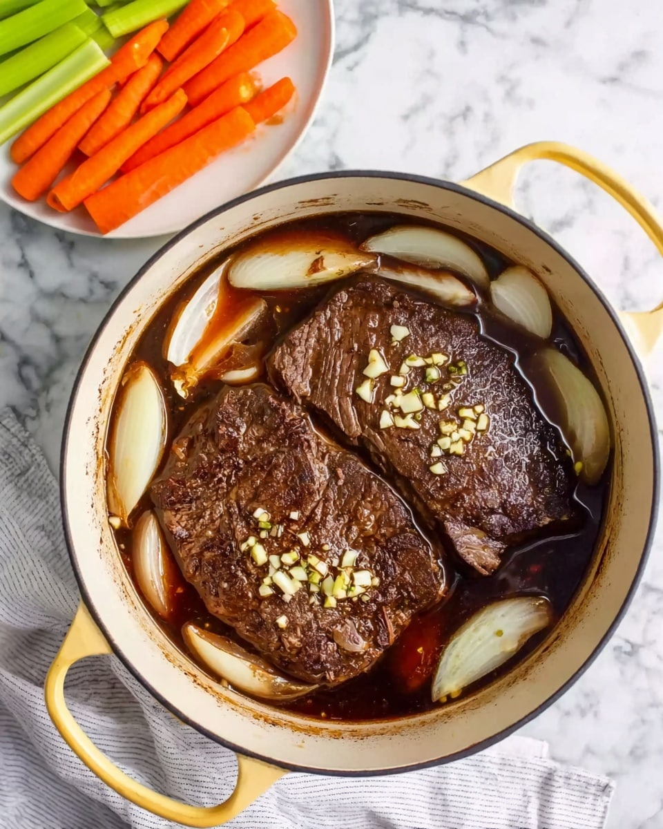 The image shows a white pot with yellow handles filled with two large pieces of brown cooked meat, covered with a dark brown liquid. Around the meat, there are large white onion pieces that are translucent, and small chopped garlic bits scattered on top of the meat. Next to the pot, there is a white plate with long pieces of orange carrots and green celery sticks. The pot and plate are on a white marbled surface with a light gray striped cloth near the pot's edge. photo taken with an iphone --ar 4:5 --v 7