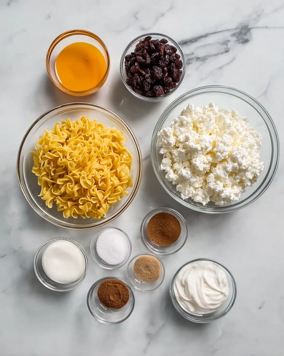 The image shows eight clear glass bowls arranged on a white marbled surface. The largest bowl in the bottom left holds yellow curly noodles. To its right is a medium bowl filled with orange beaten eggs. Above the noodles is a large bowl with white cottage cheese, and next to it on the left is a medium bowl of dark raisins. A small bowl near the top right contains white granulated sugar. At the bottom are four tiny bowls holding dark brown cinnamon, light brown nutmeg, white salt, and a small bowl of white cream to the far left. Everything is neatly organized, bright and clear, photo taken with an iphone --ar 4:5 --v 7