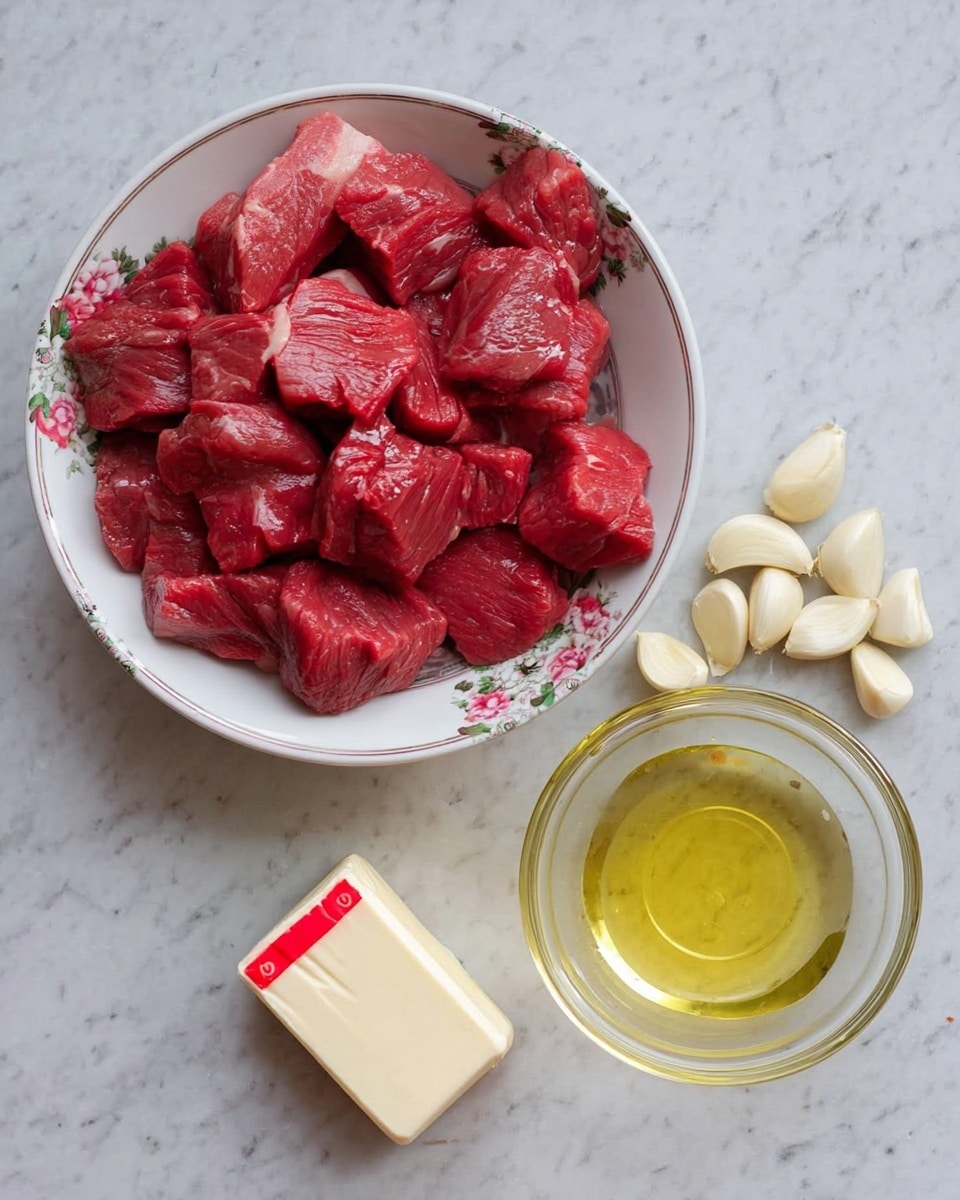 A white bowl with floral patterns holds many pieces of red raw beef in the top left part of the image. To the right, there is a clear round glass bowl filled with light yellow cooking oil. Below the bowl of oil, there are five whole garlic cloves scattered, pale yellow in color. Next to the garlic, a small block of butter with red measurement marks is placed on a white marbled surface. photo taken with an iphone --ar 4:5 --v 7