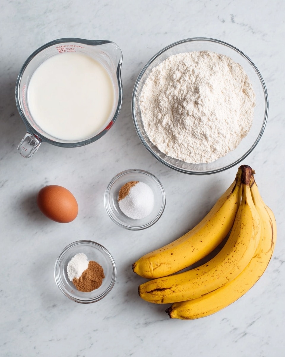 The image shows six ingredients arranged individually on a white marbled surface. In the top left is a clear glass measuring cup filled with white milk. Next to it is a medium clear glass bowl full of white flour. Above the center right is a small clear glass bowl containing three powders: light brown cinnamon, white baking powder, and white salt. Below these ingredients is another small clear glass bowl holding one brown egg. On the far right side, there are two whole ripe bananas with yellow skin and some brown spots lying next to each other. The shot is clear and bright, well-lit, photo taken with an iphone --ar 4:5 --v 7