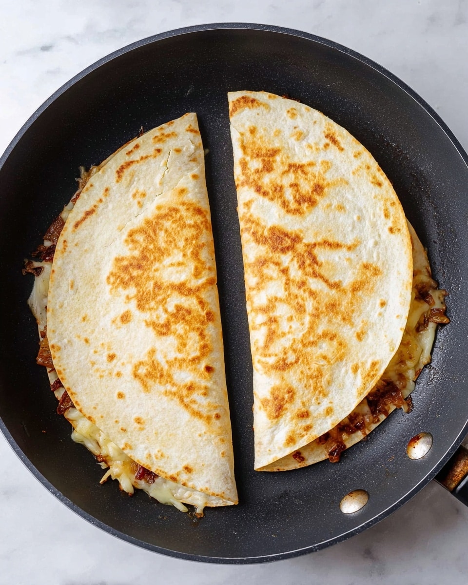 Two folded golden-brown quesadillas lie side by side in a black frying pan on a white marbled surface. Each quesadilla is made of a pale, slightly toasted tortilla folded in half, showing a textured surface with light and darker spots. The thicker edges reveal melted cheese and browned bits of filling peeking out, with some small crispy bits stuck to the pan. The pan has a matte finish with two visible rivets on the side. Photo taken with an iphone --ar 4:5 --v 7