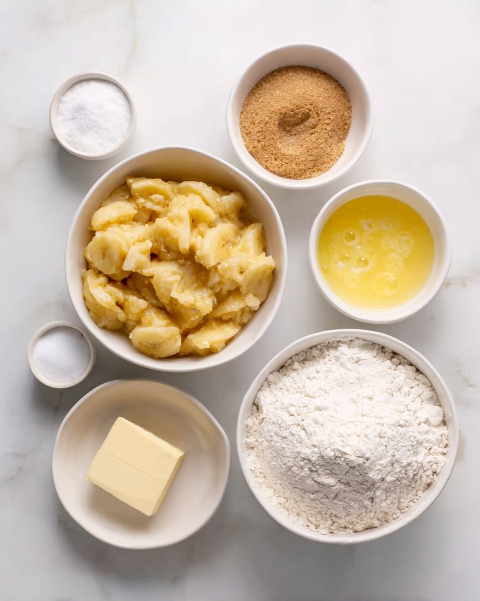 The image shows six white bowls and a stick of butter on a white marbled surface, each containing a different baking ingredient. The largest white bowl at the bottom right is filled with white flour that looks soft and powdery. Next to it, on the left, there is a white bowl filled with mashed bananas that are yellow with some small brown specks, having a slightly chunky texture. Above the mashed bananas, a small white bowl contains light brown sugar with a crumbly texture. To its right, a small white bowl has a yellow liquid, likely beaten eggs, with a foamy surface and some bubbles. Next to it, another small white bowl holds a white powder, probably baking soda, smooth and fine in texture. A small white bowl at the top left contains a small amount of coarse salt. Finally, on the right side of the bowls, a light yellow stick of butter is placed on the surface with a smooth texture. photo taken with an iphone --ar 4:5 --v 7