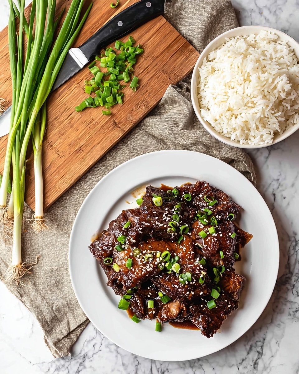A white plate holds several pieces of dark brown meat glazed with a shiny sauce, topped with small white sesame seeds and scattered bright green chopped scallions. Next to it, a white bowl is filled with fluffy white rice. Above, a wooden cutting board features chopped green scallions and a large knife with a black handle resting on a beige cloth, all placed on a white marbled surface. Photo taken with an iphone --ar 4:5 --v 7