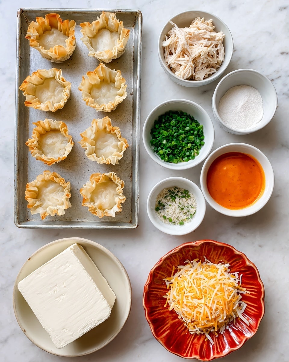 The image shows several cooking ingredients arranged neatly on a white marbled surface. On the left, there is a metal tray holding ten light brown phyllo pastry cups with crinkled edges. To the right, there are six small white bowls, each containing different ingredients: one bowl holds shredded light beige chicken at the top center, below it is a small bowl with white ranch mix powder, next to it is another bowl with small chopped bright green chives. Further right, a bowl contains bright orange buffalo sauce. Below the chives, a white scalloped bowl holds light yellow shredded cheese. At the bottom center, a red plate holds a block of smooth, white cream cheese. All items are evenly spaced on the white marbled surface, clear and well lit, photo taken with an iphone --ar 4:5 --v 7