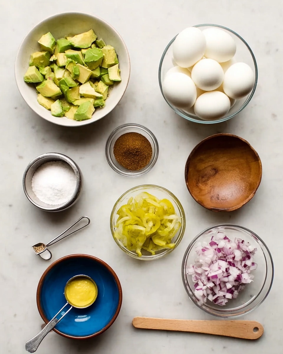 The image shows eight small glass bowls and one small wooden bowl laid out on a white marbled surface. The largest bowl holds six peeled hard-boiled eggs with a smooth white surface. To the left, a white bowl contains roughly chopped green avocado pieces. Next to it, a small round wooden bowl is filled with a dark brown powder. A small blue bowl holds white salt. A small clear glass bowl contains chopped pickles with a yellow-green color. A metal measuring cup has finely chopped red onions, showing white and purple colors. There is a metal tablespoon filled with thick yellow mustard and a tiny metal measuring spoon with a white powder. photo taken with an iphone --ar 4:5 --v 7