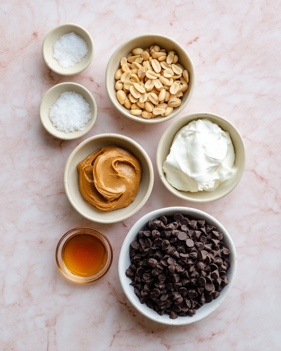 The image shows seven small bowls arranged on a white marbled surface. The largest bowl at the bottom right is filled with a pile of dark brown chocolate chips. Above it to the right is a medium white bowl filled with smooth, white Greek yogurt. To the left of it is a beige bowl holding light brown peanuts scattered loosely. Above the peanuts to the left is a small white bowl with light brown peanut butter. At the top center are two small beige bowls, one containing a dollop of coconut oil and the other filled with flaky white sea salt. To the right of these is a small glass bowl holding a golden brown liquid, likely maple syrup. photo taken with an iphone --ar 4:5 --v 7