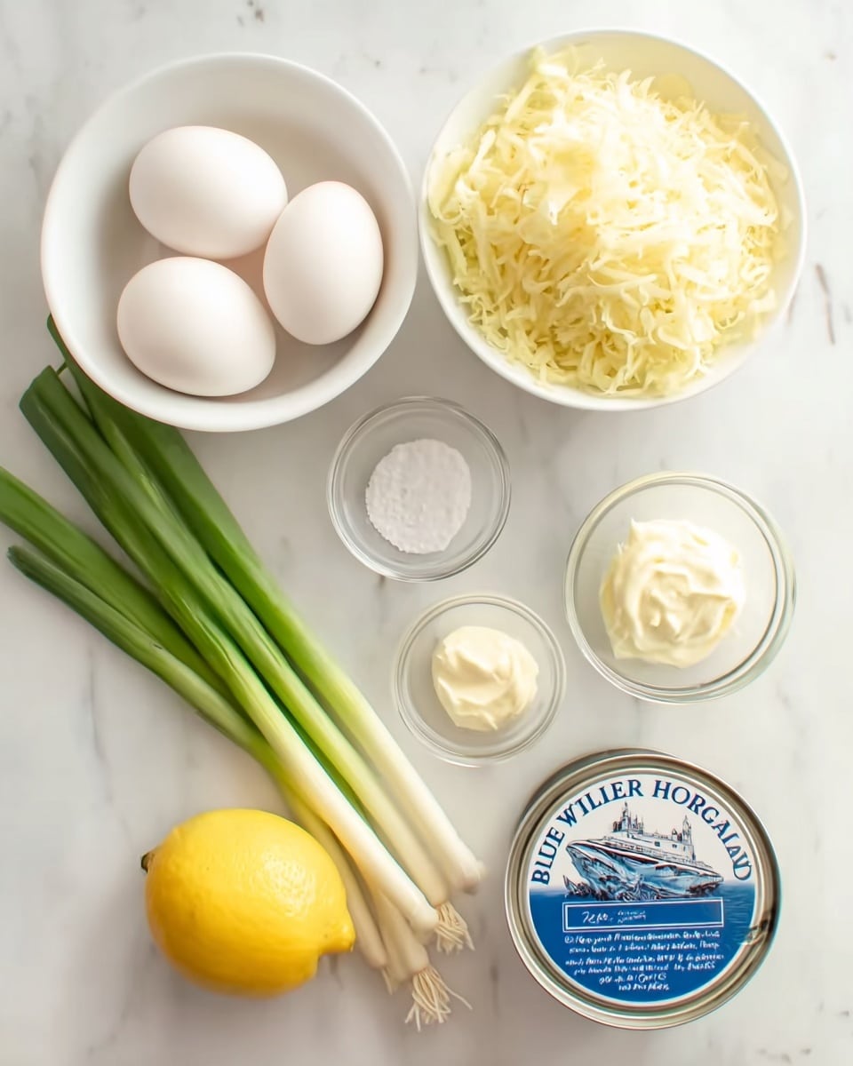 A top-down view shows ingredients arranged neatly on a white marbled surface. In the bottom left, a white bowl holds three whole white eggs. To the right of this bowl, three long green onions lie horizontally with their white roots to the right. Above the eggs is a larger white bowl filled with shredded pale yellow cheese. To the right of the cheese, there are three small glass bowls: one with white granulated salt, one with a dollop of creamy white mayonnaise, and a halved bright yellow lemon. Finally, at the bottom right corner, a closed metallic can with a label that reads