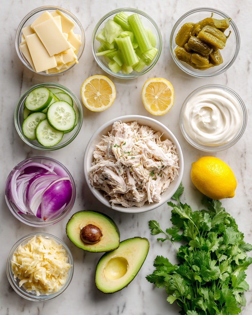 The image shows a collection of fresh ingredients arranged neatly on a white marbled surface. In the center, there is a white bowl filled with shredded chicken, light beige in color and textured. Surrounding it are small glass bowls containing green celery pieces, sliced yellow-green pickles, chopped purple-red onion, and thin slices of pale yellow cheese with spicy specks. Two halves of a bright green avocado with brown seeds are placed nearby, along with a small white bowl of white creamy yogurt and a swirl of light yellow mayonnaise. Two halved bright yellow lemons, one whole lemon, and a bunch of fresh green cilantro with leaves and stems add more color and freshness to the setup. Photo taken with an iphone --ar 4:5 --v 7