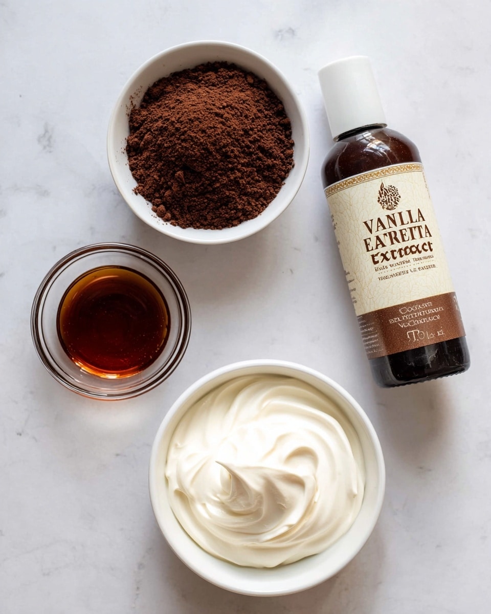 The image shows four ingredient containers on a white marbled surface. In the top left, there is a small white bowl filled with dry, dark brown cocoa powder, crumbly in texture. Below it, a small round glass bowl holds a smooth, dark amber liquid, likely vanilla extract. To the right, a tall brown bottle labeled