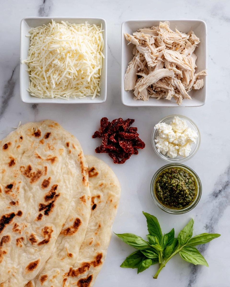 The image shows several ingredients arranged on a white marbled surface. There are two white square bowls at the top; the left one is filled with shredded white cheese and the right one contains shredded light brown cooked chicken. Below are small piles of dark red sun-dried tomatoes, a small glass bowl with green pesto, and another glass bowl of white crumbled cheese. On the left side, there is a large, lightly browned flatbread with char spots. At the bottom right, a small bunch of fresh green basil leaves adds a fresh touch. Photo taken with an iphone --ar 4:5 --v 7