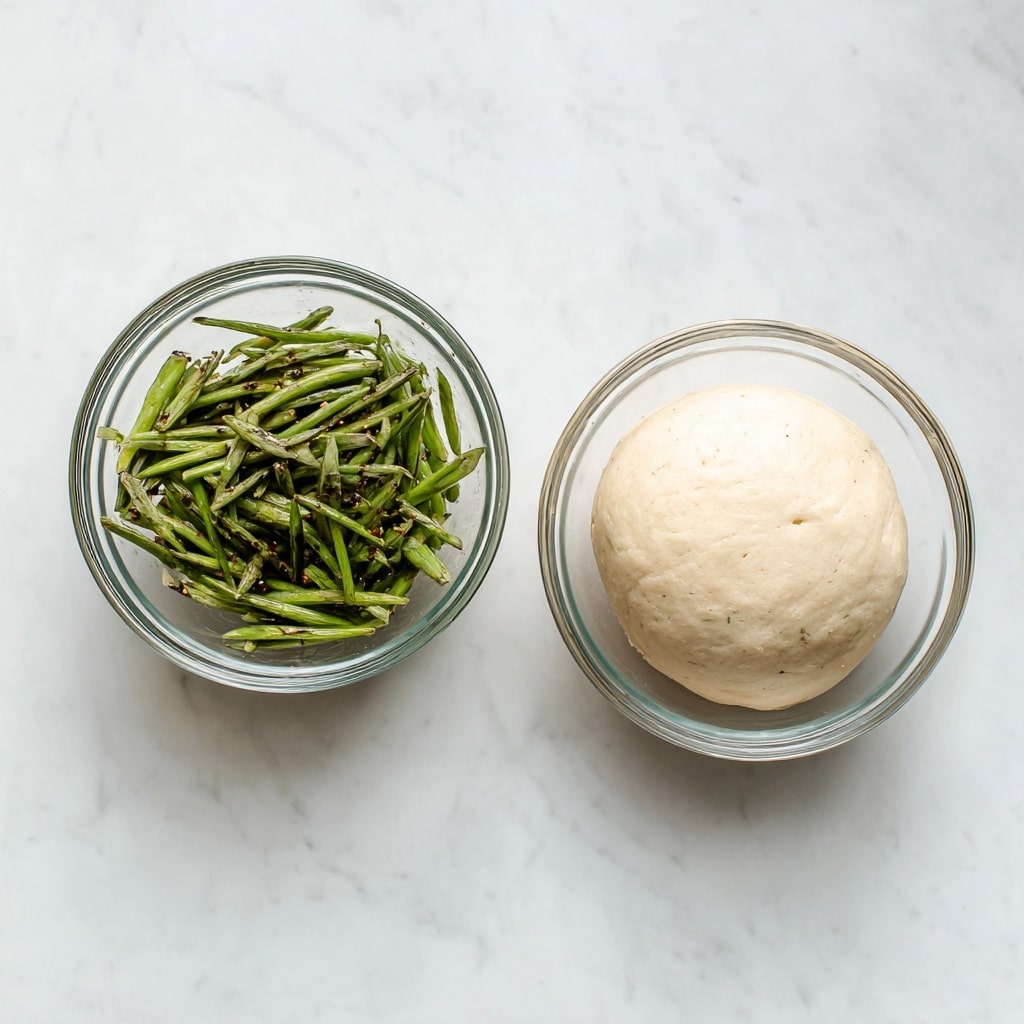 The image shows two small clear glass bowls placed side by side on a white marbled surface. The bowl on the left contains green vegetable sticks, looking fresh and slightly seasoned with small dark specks. The bowl on the right holds a smooth, pale round dough ball, resting evenly at the bottom of the bowl. Both bowls have simple, clean lines and clear glass texture, allowing full view of their contents. photo taken with an iphone --ar 4:5 --v 7
