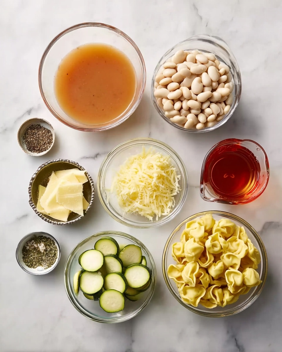 The image shows eight clear bowls arranged on a white marbled surface. The largest bowl near the top center holds light brown broth with a smooth texture. To the right of it, a medium bowl holds white beans, round and plump. Below this bowl, another medium-sized bowl contains small yellow tortellini pasta, each piece curled and inviting. To the right of the pasta, a small bowl is filled with grated pale yellow cheese. On the left side of the broth, there is a small bowl with sliced green zucchini, thin and round with a slight glossy shine. Below this, another small bowl has dry herbs in dark green flakes. Below the herbs, a small bowl contains black pepper with a speckled texture. Above the herbs, a tiny glass measuring cup holds reddish-brown liquid. To the left of the broth, a flat tin with red tomato chunks is also visible. All bowls are clear and placed neatly, and the scene is bright and clean, photo taken with an iphone --ar 4:5 --v 7