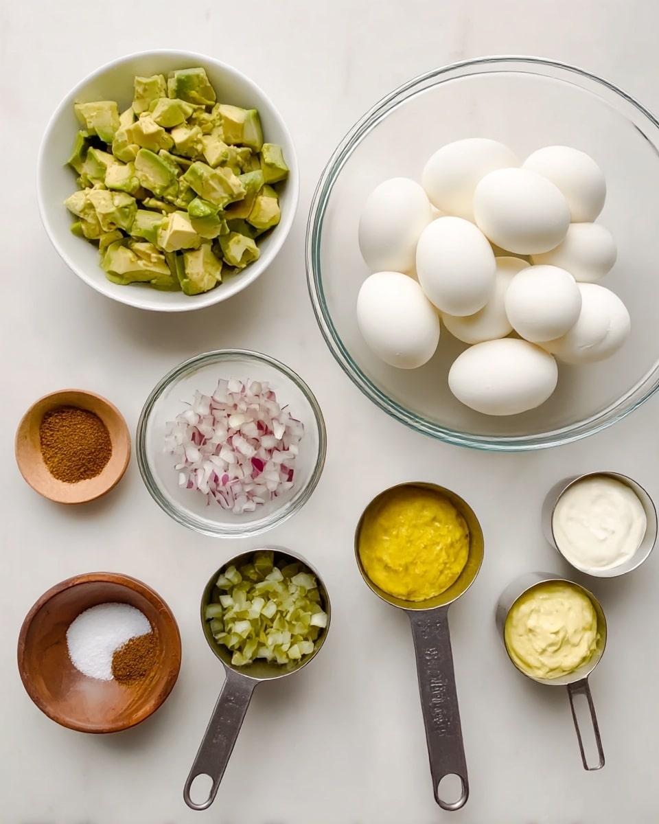 The image shows several clear and white bowls and metal measuring cups arranged neatly on a white marbled surface. There is a large clear bowl on the right filled with six whole white peeled boiled eggs. To the far left, there is a white bowl with chopped chunks of green avocado. Below it, there is a small wooden bowl holding brown spices, and next to it a small white bowl with white salt. In the middle, there is a small clear bowl with chopped green pickles and above it a metal measuring cup filled with finely chopped red onion. To the right of it, a metal measuring cup with bright yellow mustard and a smaller one at the top right with white creamy mayo or sauce. The setup looks clean and organized, ready for making a dish. Photo taken with an iphone --ar 4:5 --v 7