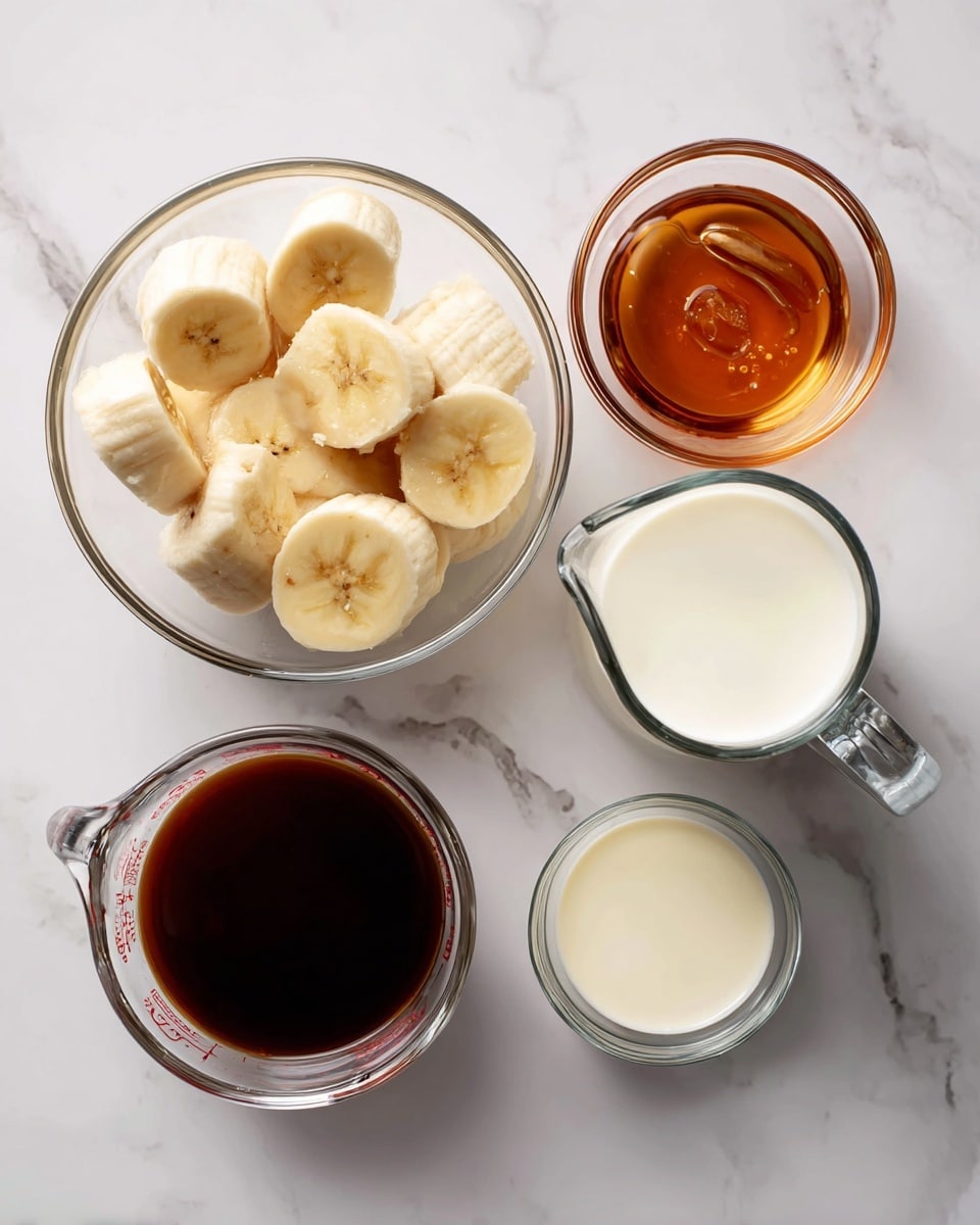 The image shows five clear glass containers arranged on a white marbled surface. At the top left, a glass bowl holds sliced frozen bananas, with pale yellow flesh and some brown spots. To the right, a small glass bowl contains amber-colored maple syrup. Below it, a clear glass pitcher is filled with white milk that almost reaches the rim. In the center, a glass measuring cup holds dark brown cold coffee with a smooth surface. Below the bananas, a small glass cup contains dark brown vanilla extract. Each ingredient is evenly spaced, displaying different shades of brown, cream, and white, with clear, clean glass highlighting the colors and textures. Photo taken with an iphone --ar 4:5 --v 7