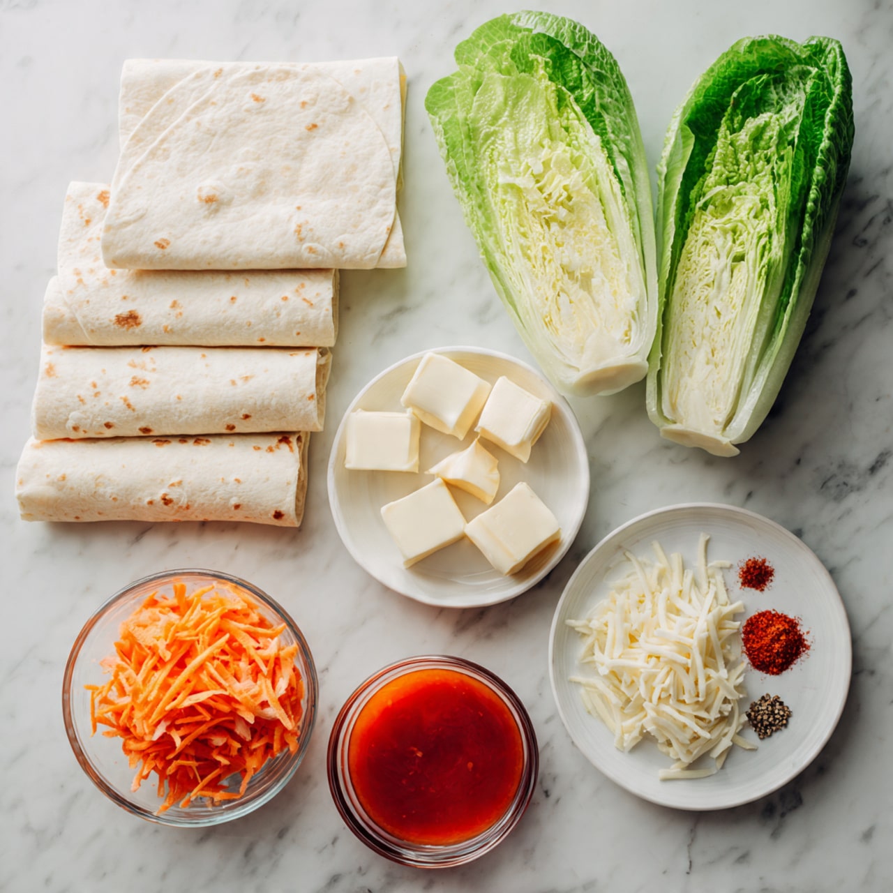 The image shows ingredients for a dish set on a white marbled surface. On the left, there are four folded white tortillas stacked in a small pile. Next to them are three large green romaine lettuce leaves with a crisp and fresh texture. To the right, there are several small bowls and a white plate: the plate holds three rectangular blocks of butter, one small glass bowl contains shredded orange carrots, another has shredded white cheese, and a third glass bowl holds three raw chicken fillets, light pink in color and smooth in texture. There is also a small glass bowl of bright red-orange sauce and a tiny glass bowl with red, white, and beige spices arranged in small separate piles. Photo taken with an iphone --ar 4:5 --v 7